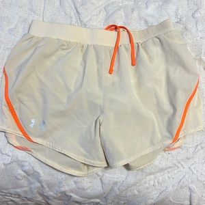 Women’s cream and orange Under Armour shorts.